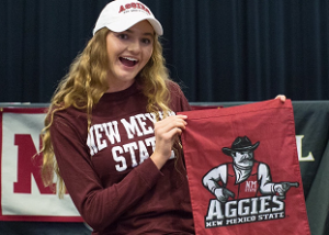 Signing Goes Swimmingly: Olivia Bender pens her signing to New Mexico State University. “This is the reason I wake up at 4am,” says Bender in her Twitter post. Picture taken from @OliviabBender account on Twitter.