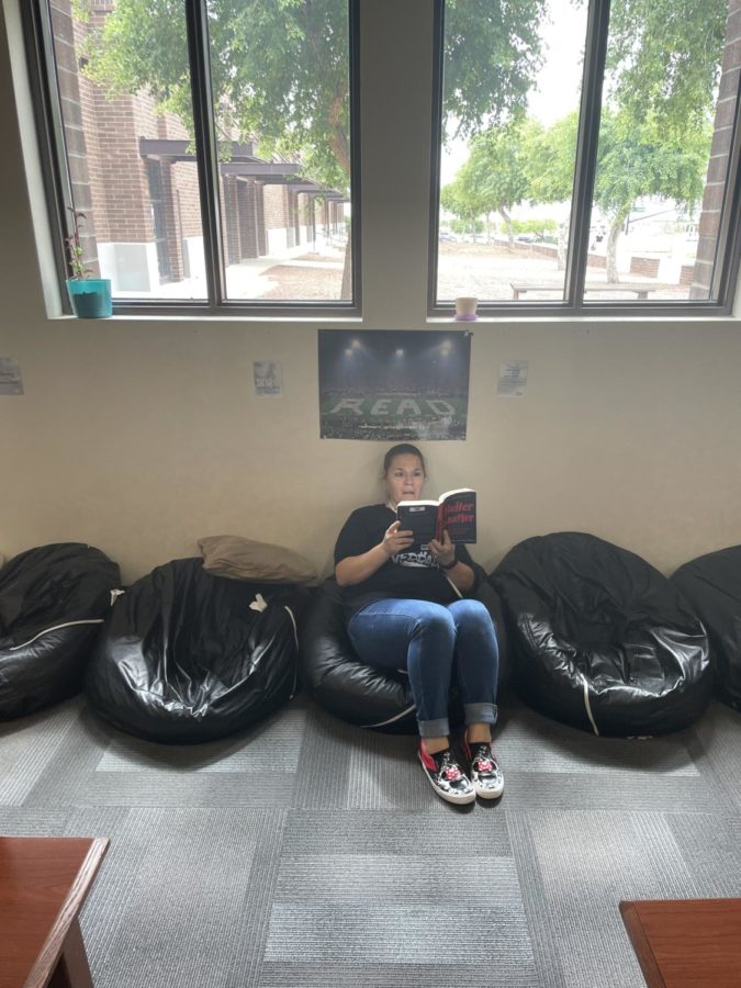Mrs. Warren finds a comfy spot to read in the Verrado Library before the next group of students comes in. 