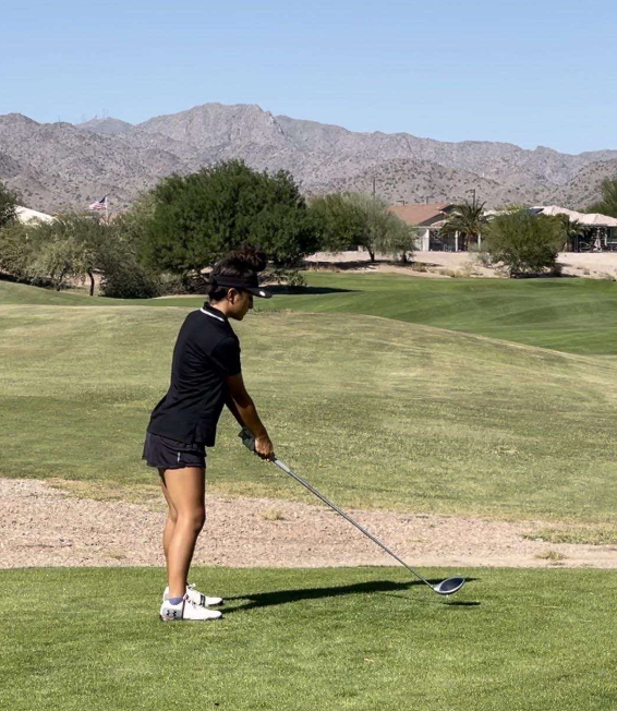 Camryn Corralejo getting ready to hit a drive off the tee box.