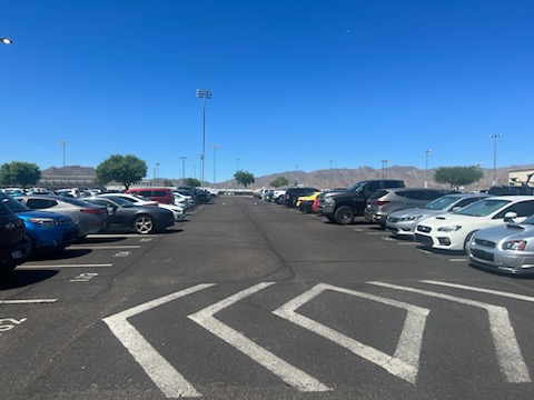 The Verrado High School parking lot full of cars during the school day.