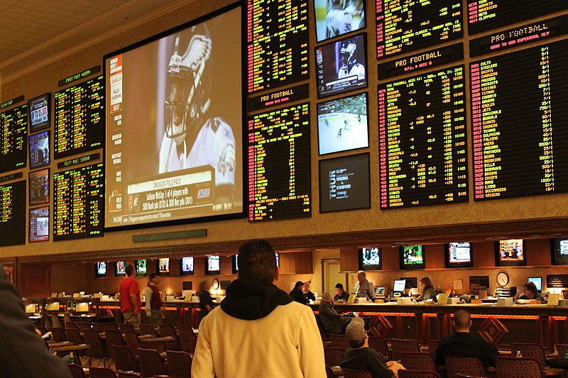 An "odds board" in a sportsbook at a Las Vegas casino displaying the potential outcomes of multiple sports games, namely football.