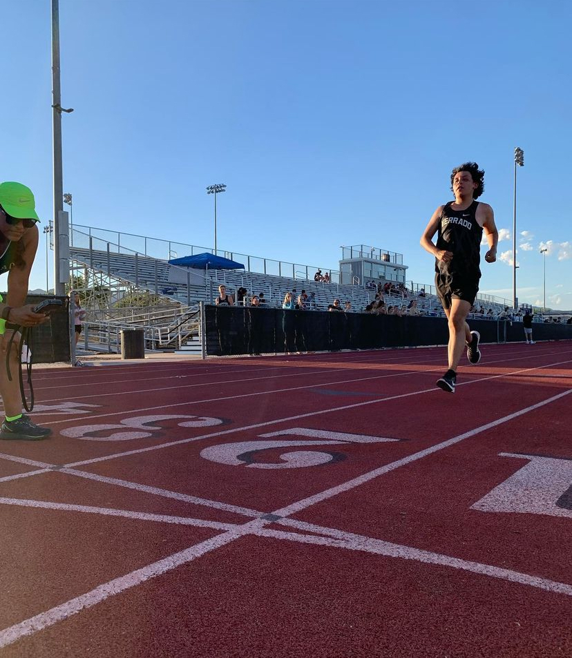 A Verrado runner crossing the finish line at the home cross country meet.