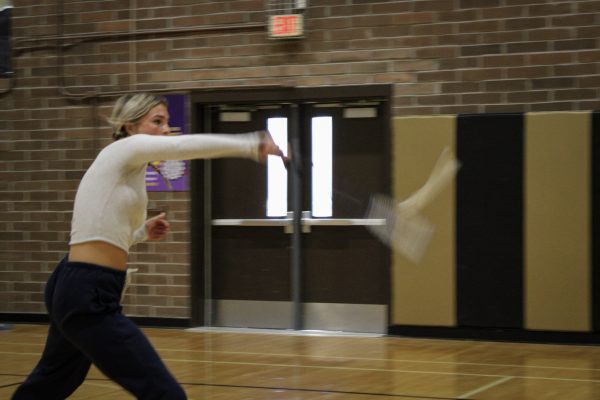 Verrado badminton player smacks the birdie with her racket.