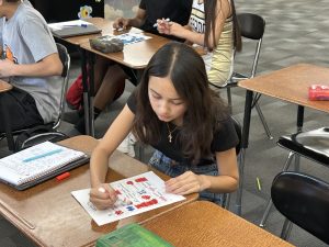 Students in Ms. McCloud's Freshman Experience class work to win Music Bingo. 