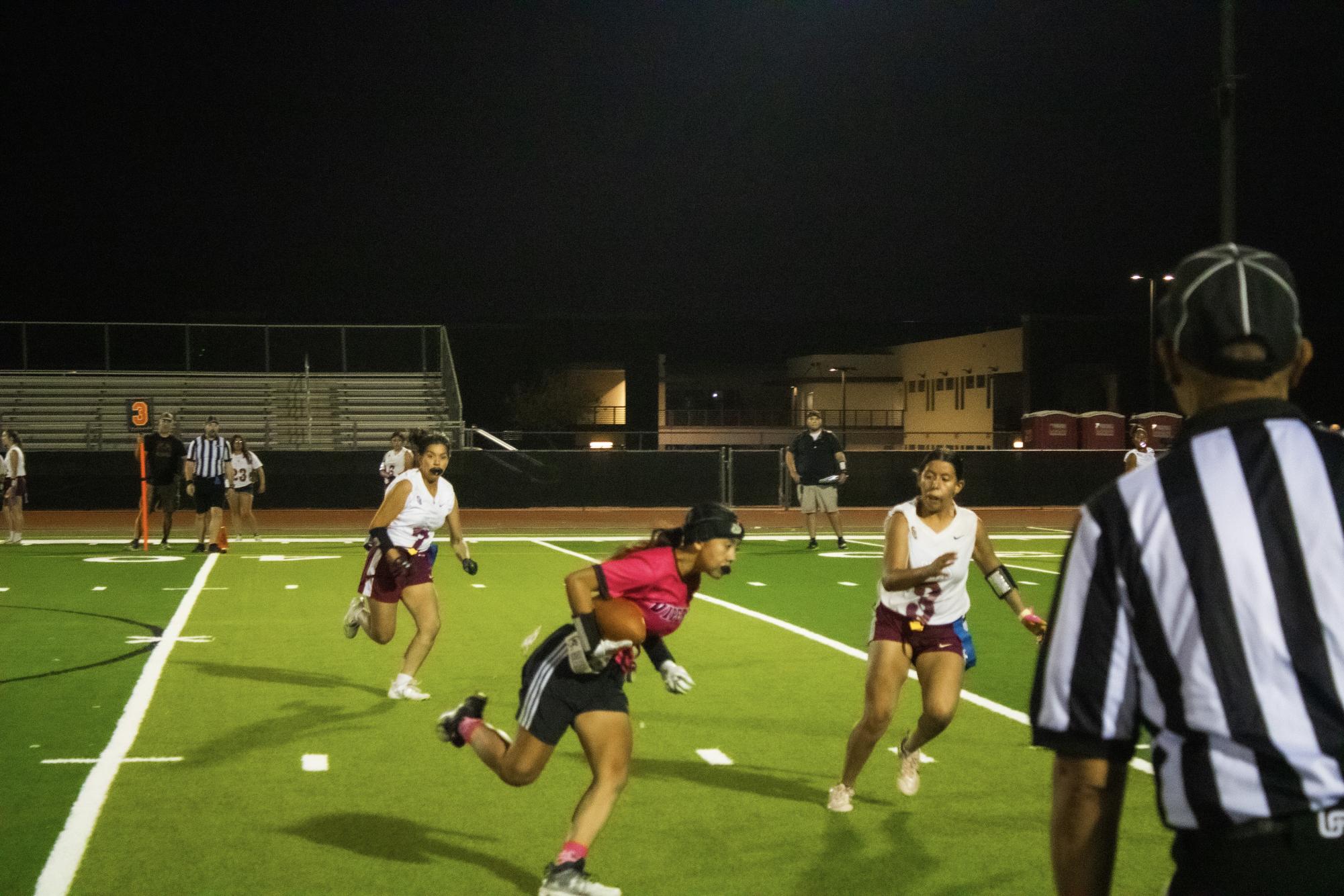 Player Allison Rospierski catches the football then started down the sideline.