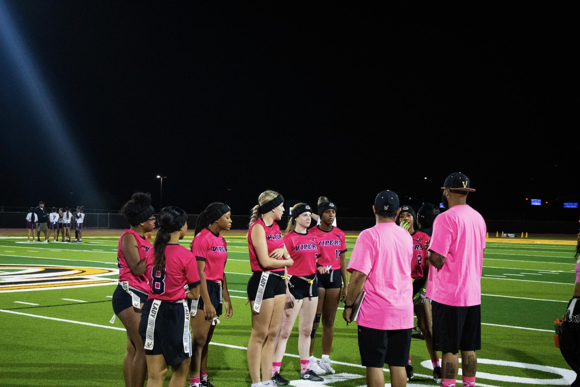 Lady Vipers discuss the next play with their coaches during a recent "Pink Out" game. Photo used with permission by Louie Malave