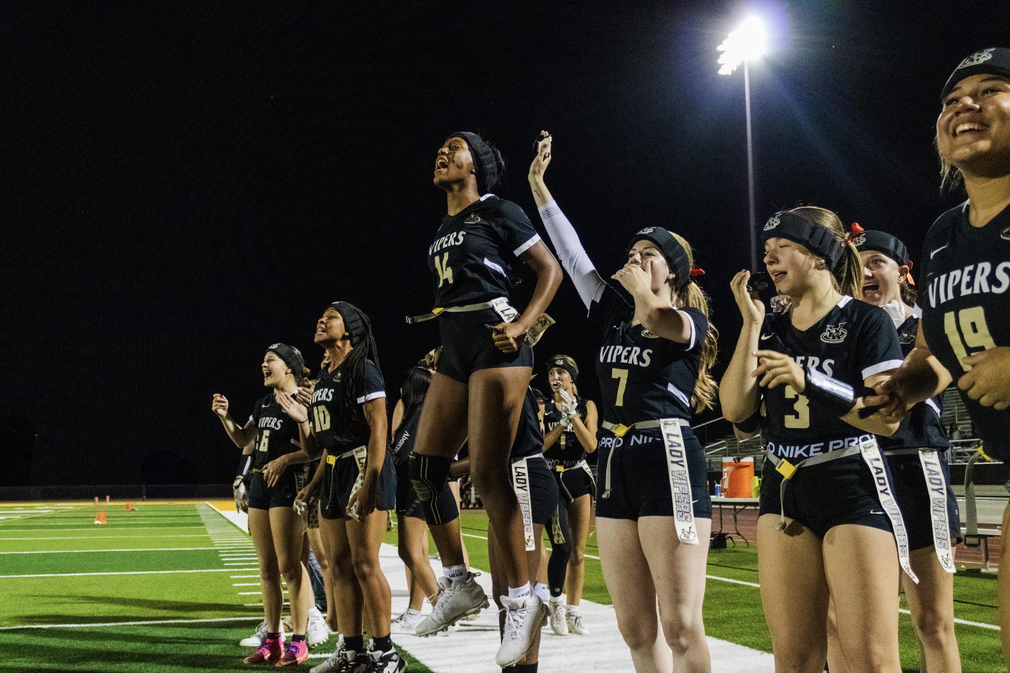 Viper Flag Football team members cheer during a recent home game. Photo by Madison Allen.