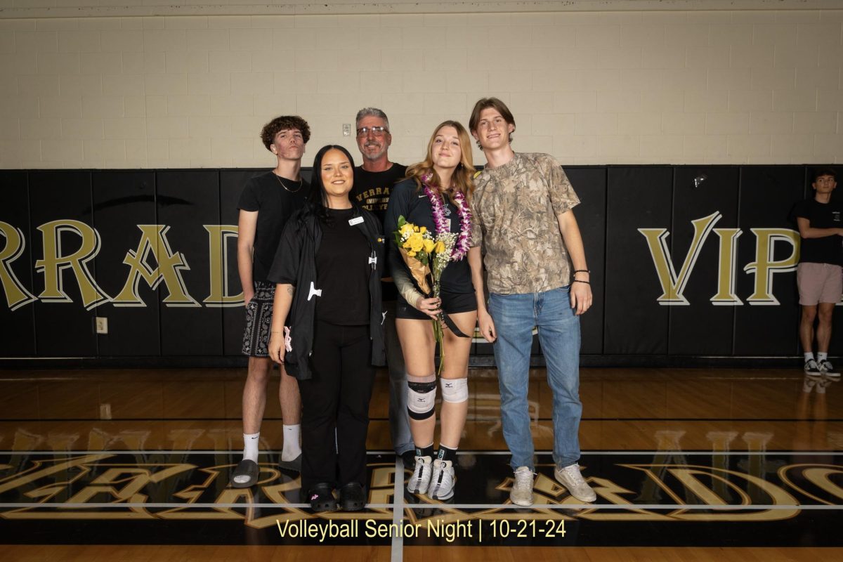 Sophia Berger wearing her volleyball uniform, her family by her side. Photo courtesy of Vernon Beard. 