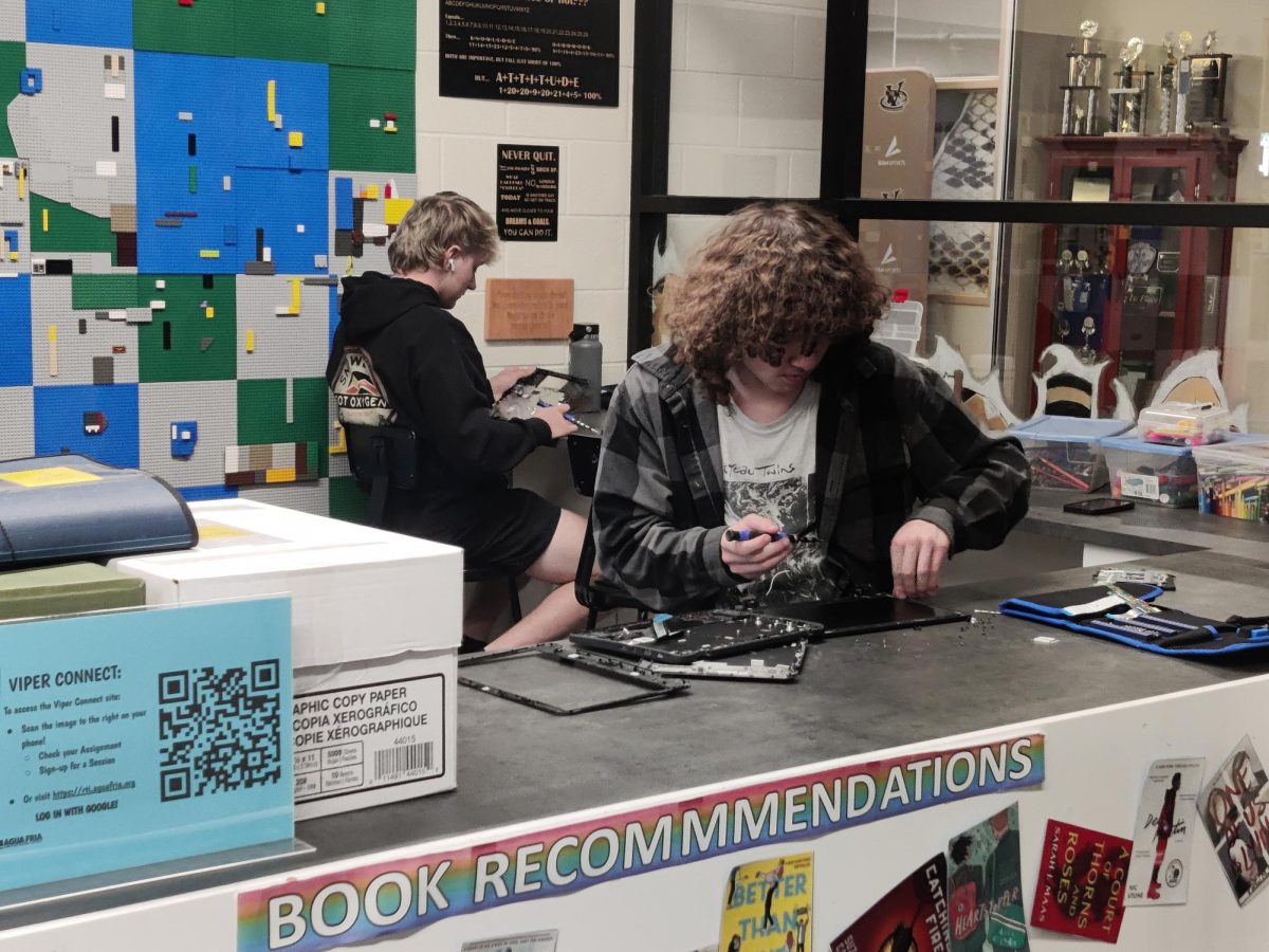 I.T. internship students Nolan Raissle and Christian Scott working on Chromebooks.