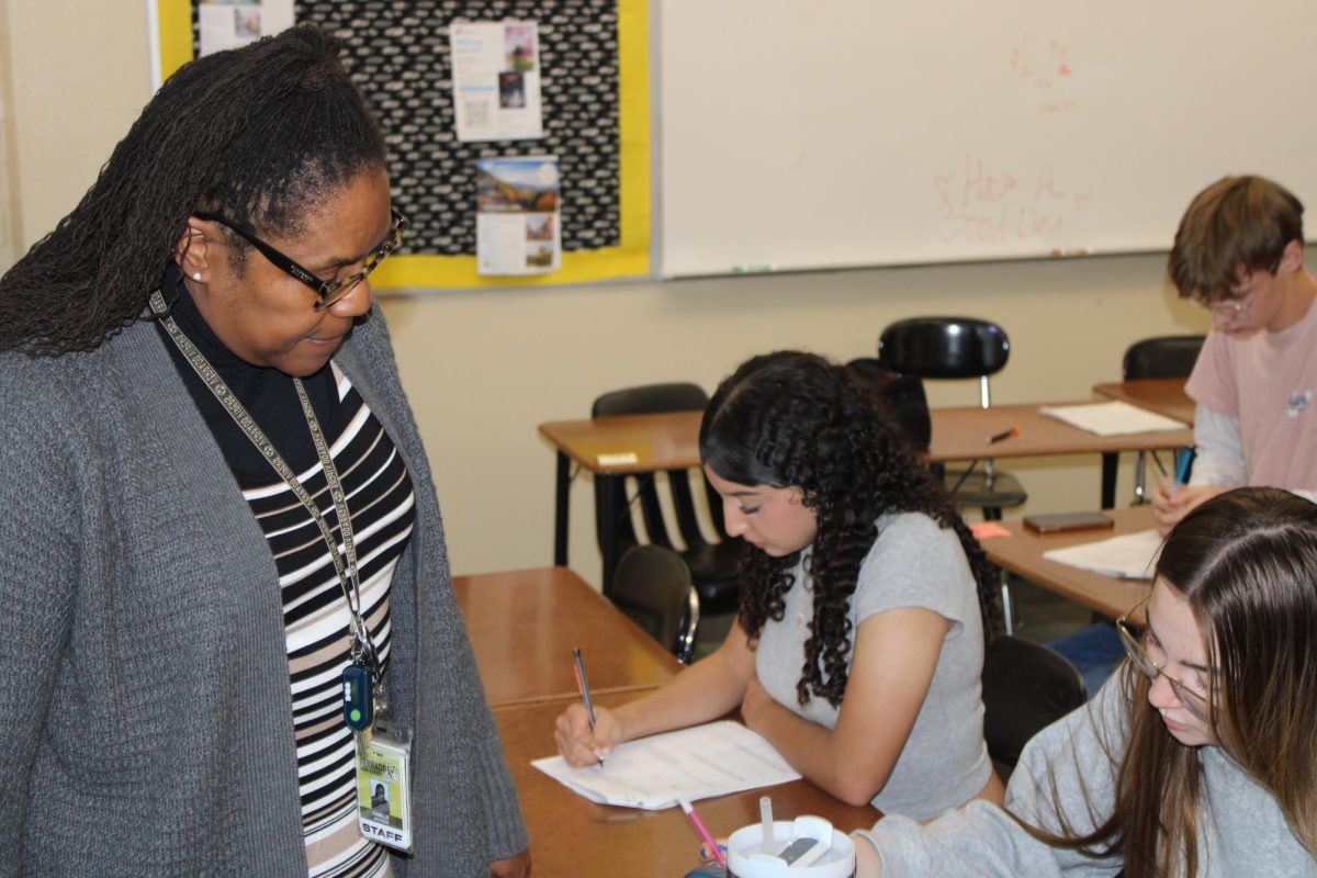 Mrs. Jackson helping her students fill out their notes during her Honors Algebra II class.