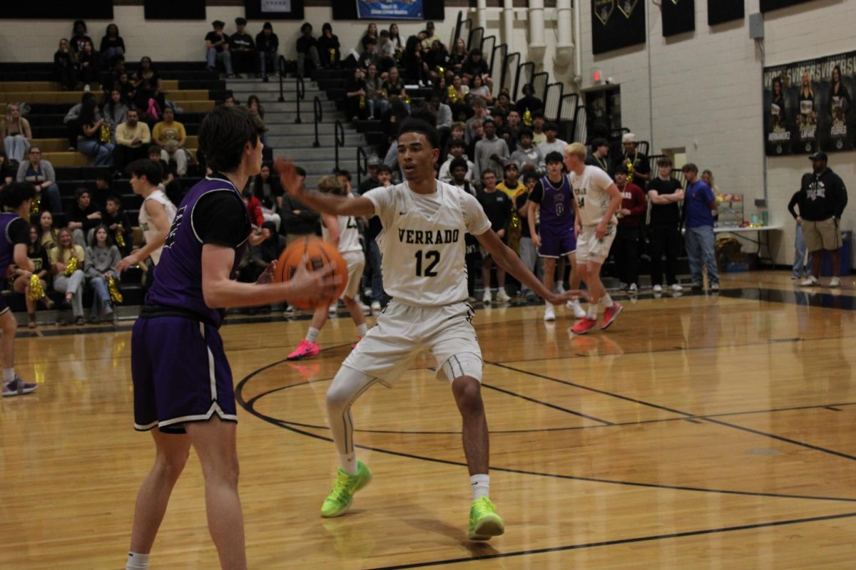 Amari Fletcher (Sr.) guards a AZCP player with his right hand blocking his left side. 