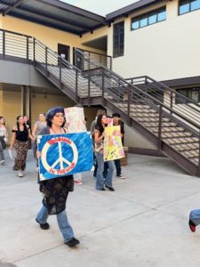 Student "protestors" march into Verrado High during One World, One Verrado. The protest was part of a cross-curricular project on Protest Music.