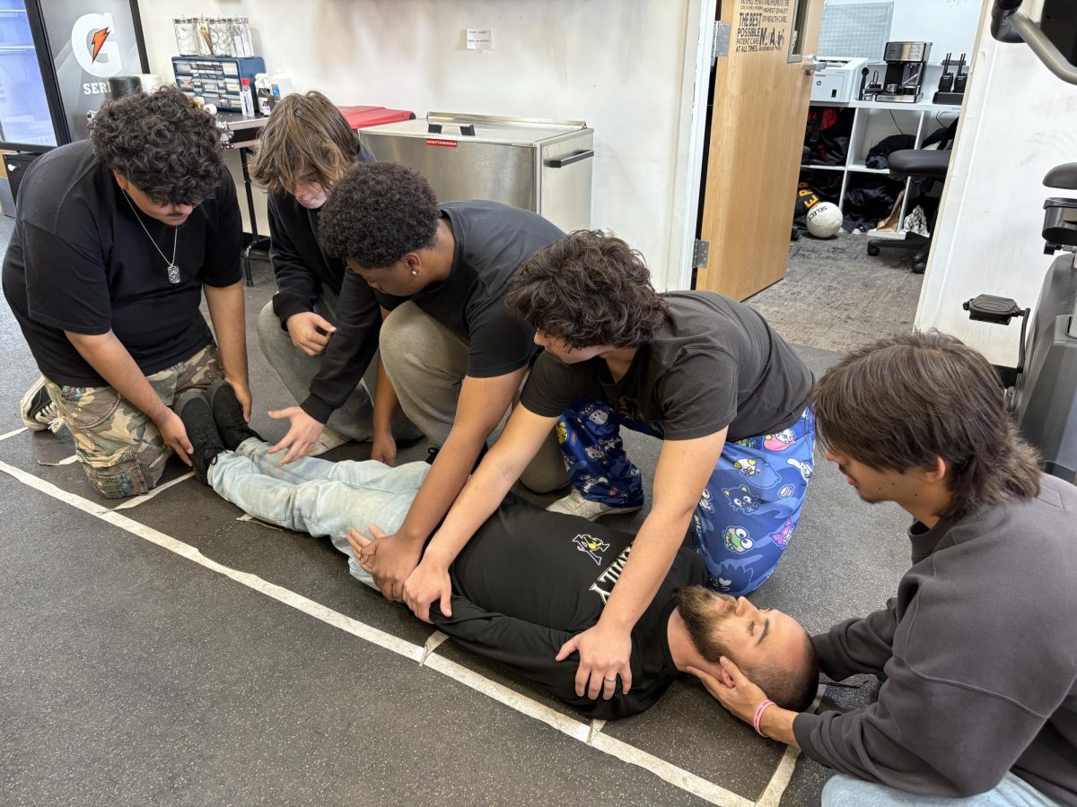 Mr. Martindale has students performing an act to lift an injured athlete