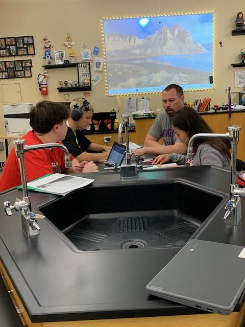 Mr. A discusses the day's topics with his students.