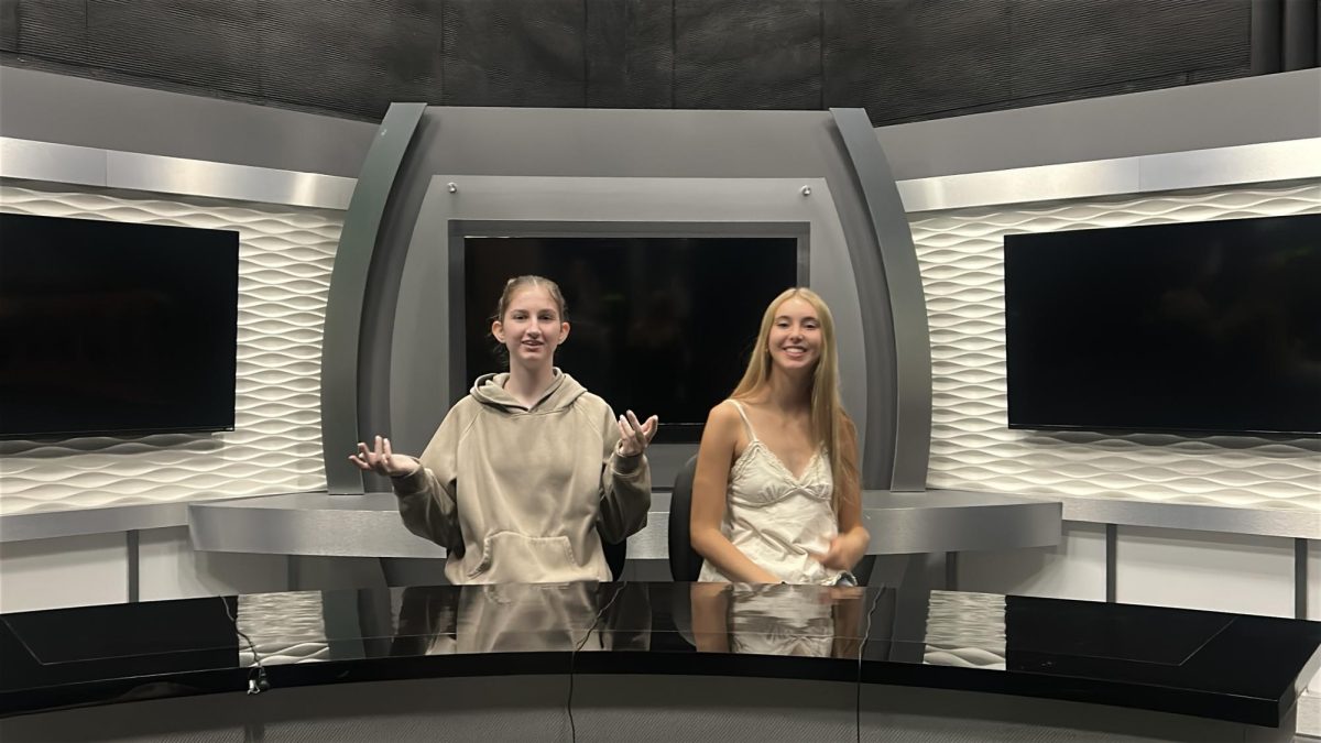 Abby and Skylee doing their news anchor in a production room at Walter Cronkite.