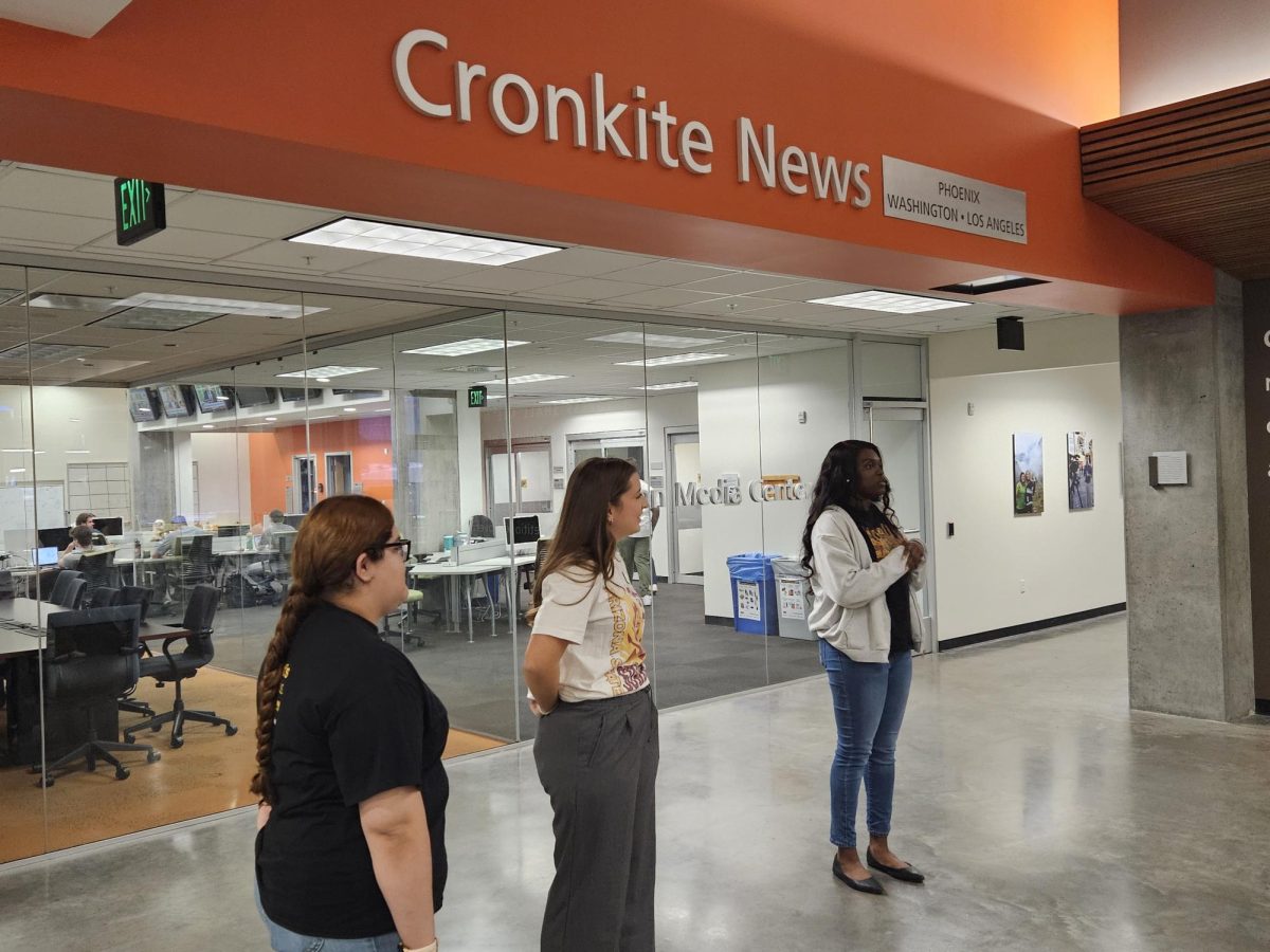 Walter Cronkite senior students and a sophomore showing The Viper Times staff the media center.
