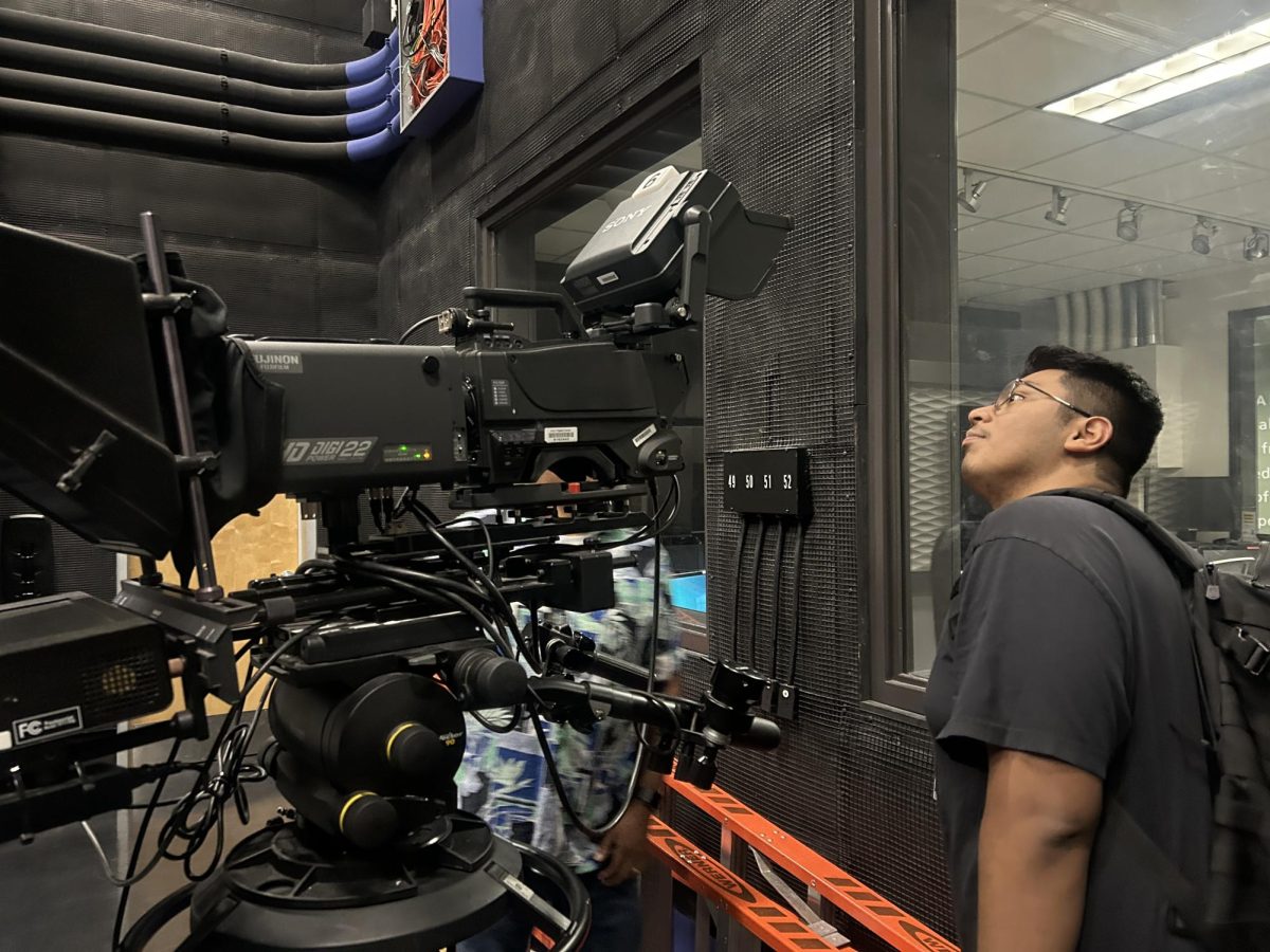 Jacob analyzing the cameras in one of the production rooms at Walter Cronkite.
