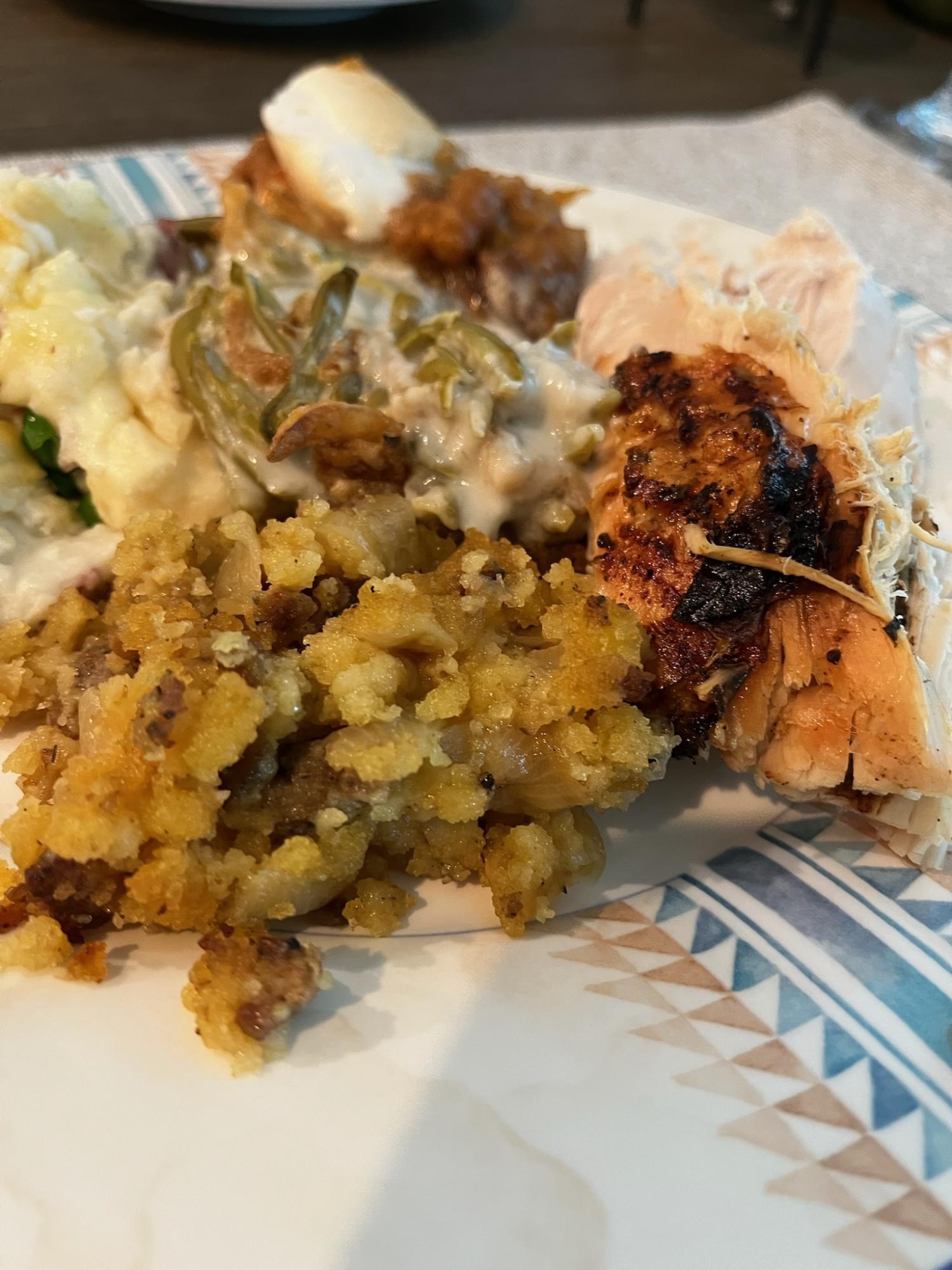 A photo of Ms. Studts Thanksgiving plate containing mashed potatoes, green bean casserole, candied sweet potatoes, dressing, and turkey