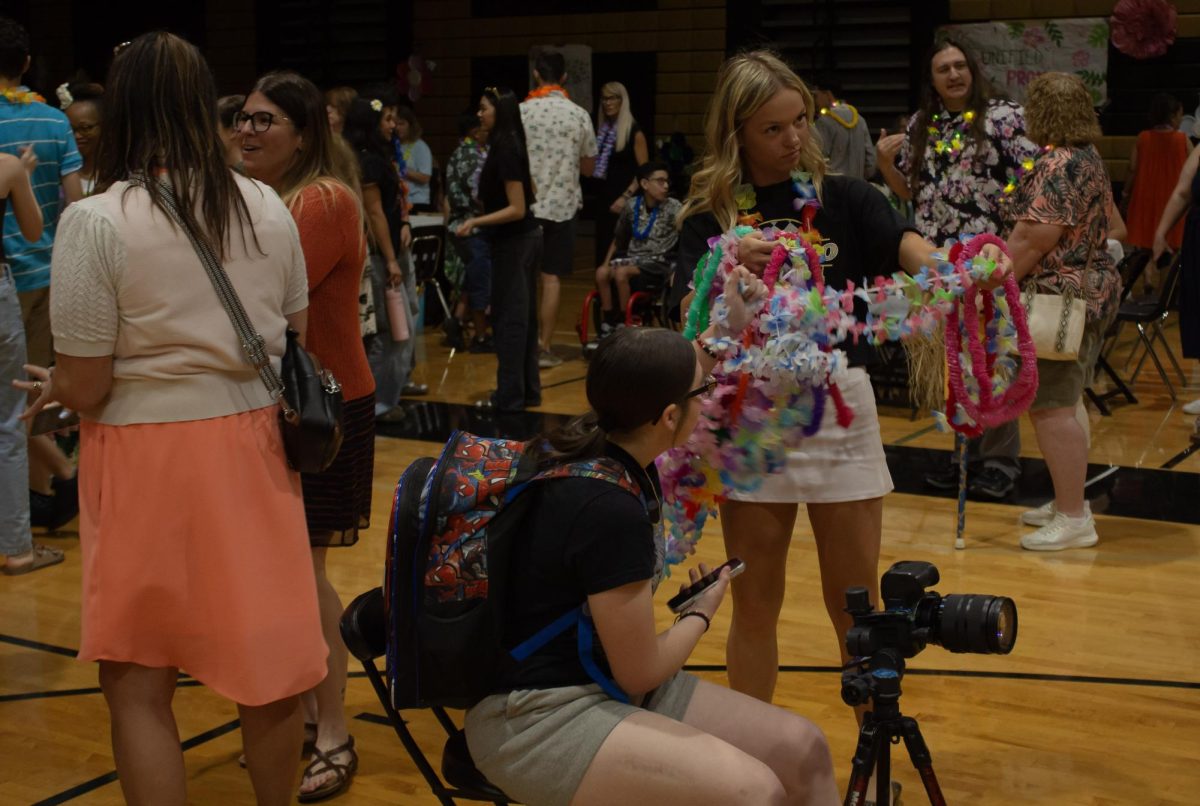 Students handing out flower necklaces at the VHS unified prom