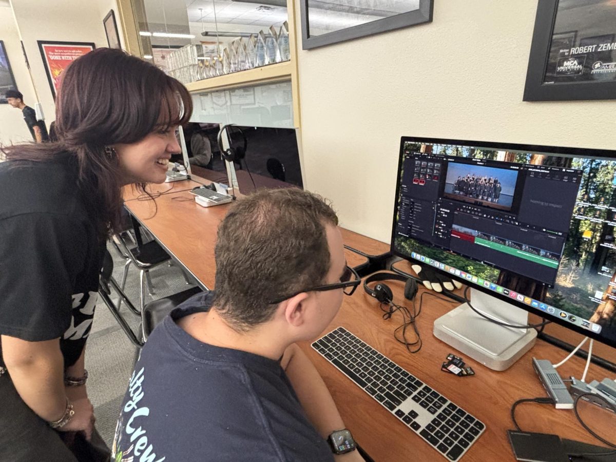 Rae Cassidy mentoring one of the film students about editing his video.