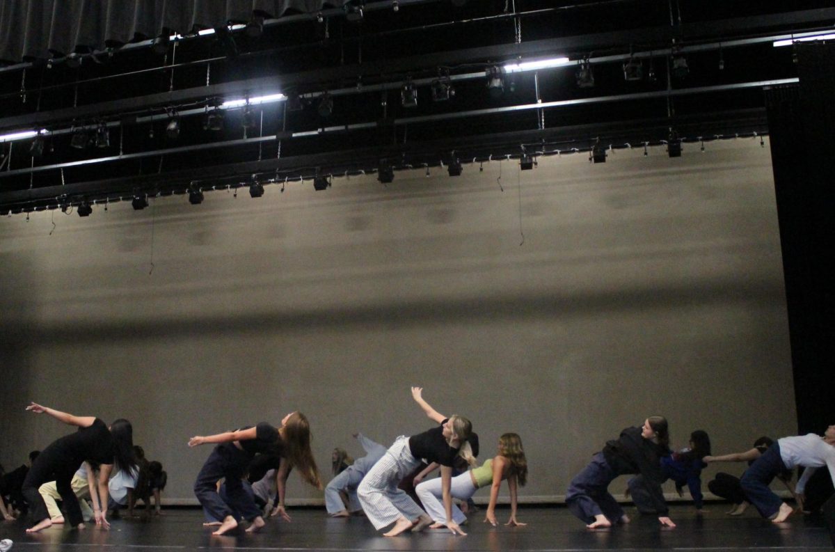 Verrado dance team practices choreography together during after school rehearsal on stage.
